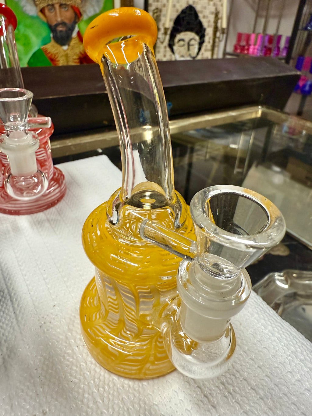 Close-up of Ripkitty 5" fancy mini bong base and bowl joint — rod yellow color glass detailing visible