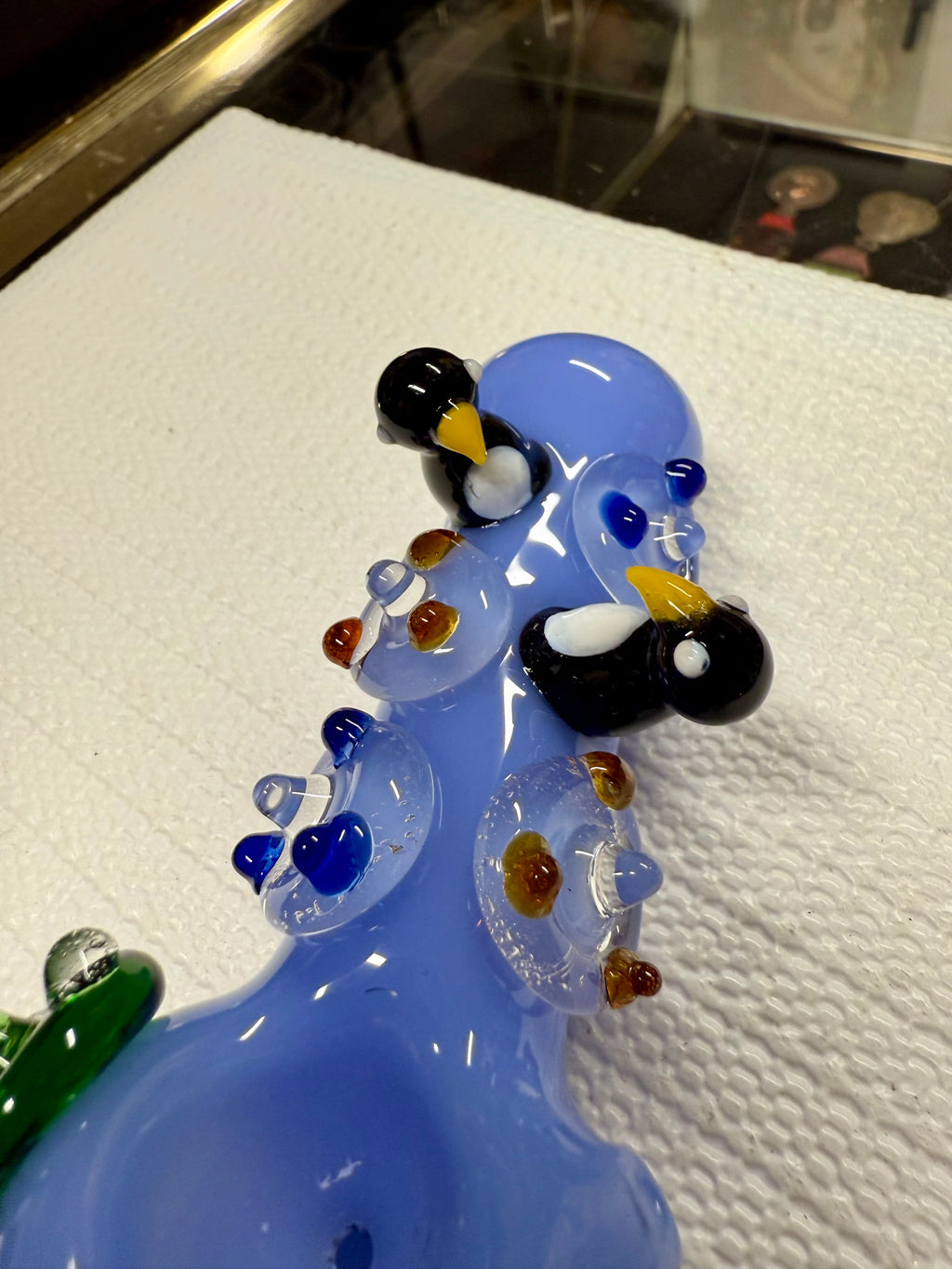 Ripkitty penguin art spoon pipe mouthpiece detail — periwinkle blue glass with penguin sculpt and dot pattern close-up