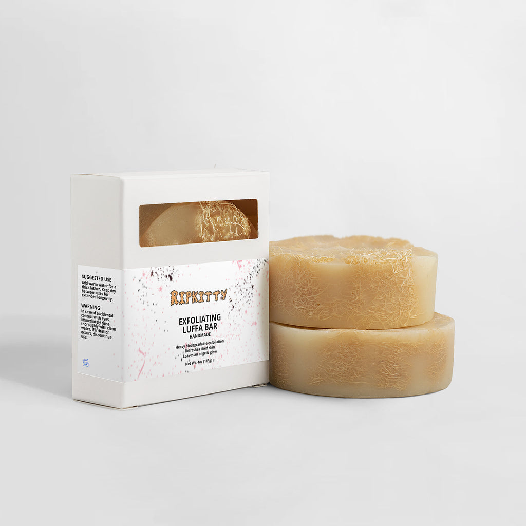 Two exfoliating luffa bars and their packaging on a white background