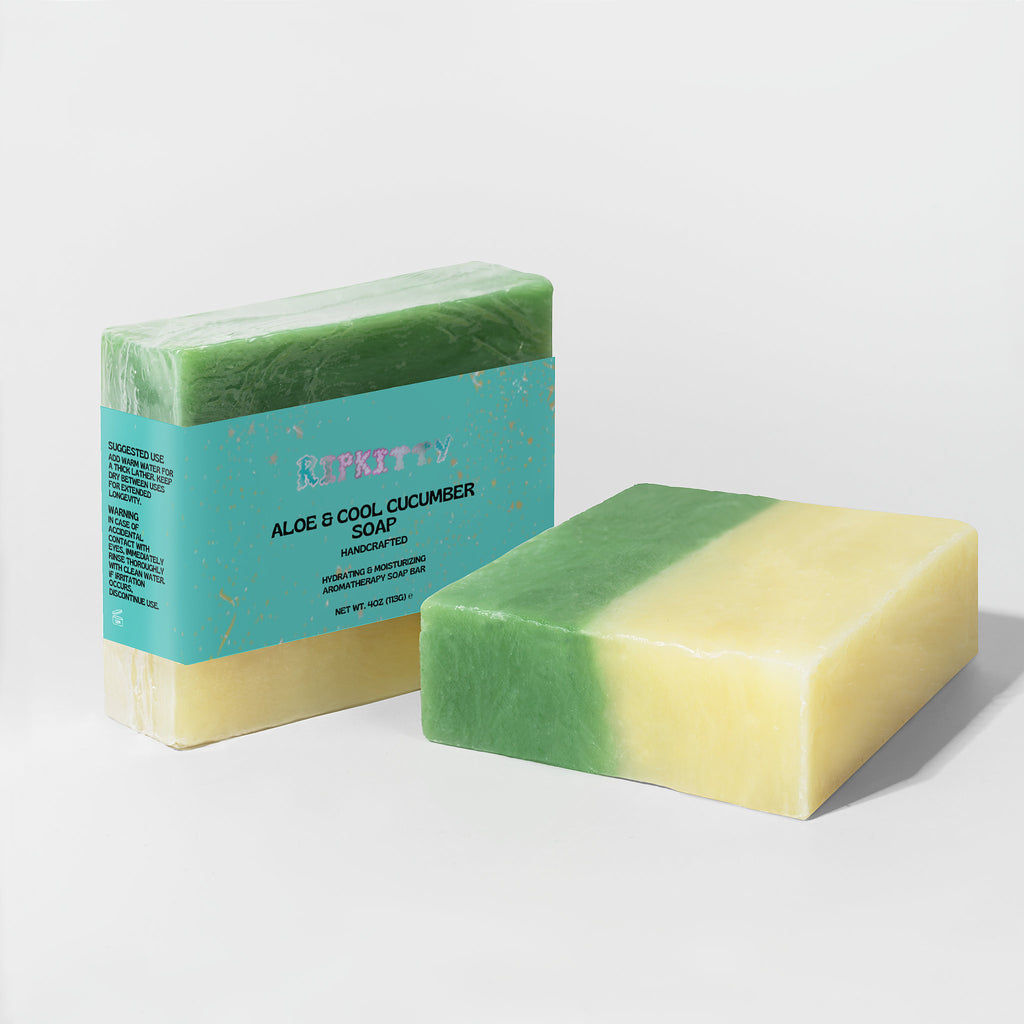 Two bars of soap with a green and yellow gradient, one with a visible label on a light gray background.