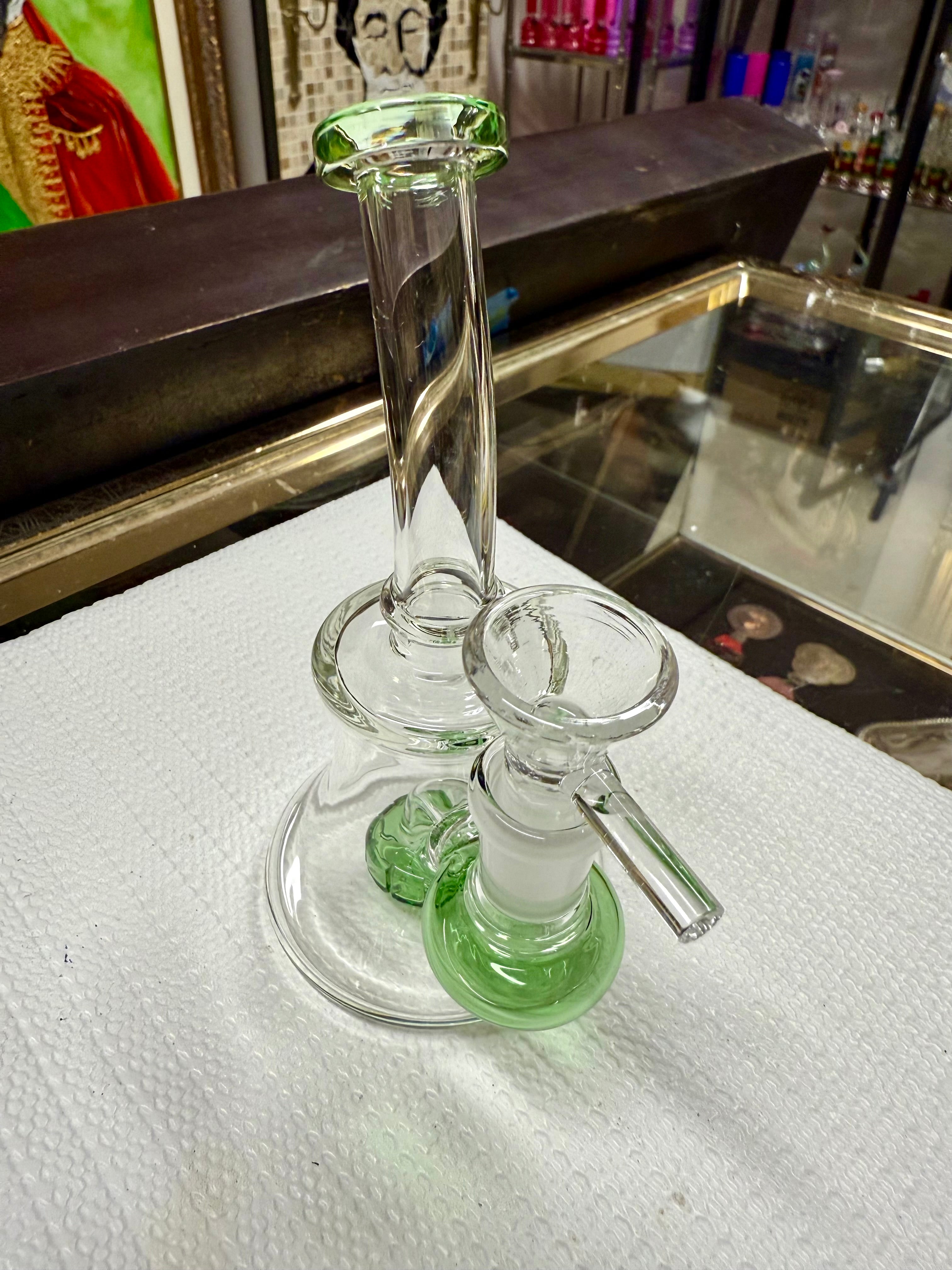 Ripkitty 7" conical bong — color shower neck, green base accent, angled overhead view showing mouthpiece, neck twist, and bowl joint