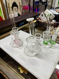 Ripkitty 7" conical bong with color shower percolator — iridescent fumed neck with twisted color pull, green base accent, 14mm male funnel bowl inserted, white background