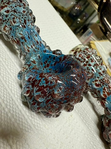 Ripkitty 5" blue spike spoon pipe — close-up of bowl chamber showing teal-blue and dark red frit interior with raised bubble nodule surround, white background