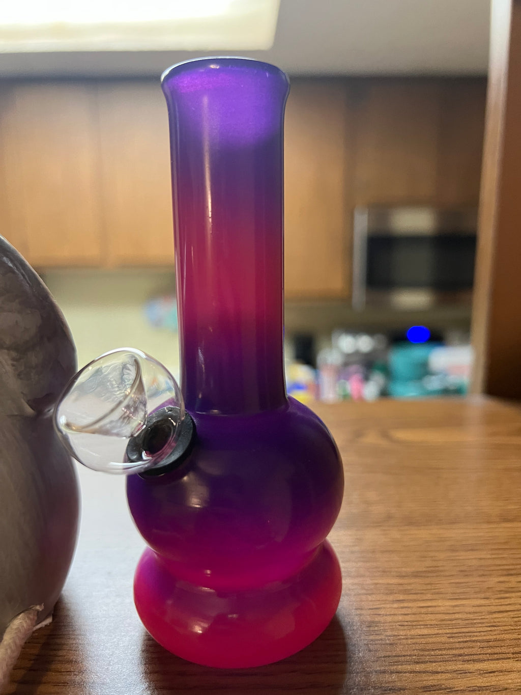 Ripkitty 5-inch soft glass water pipe, purple to hot pink gradient, smooth bubble base, clear bowl piece inserted, kitchen counter background