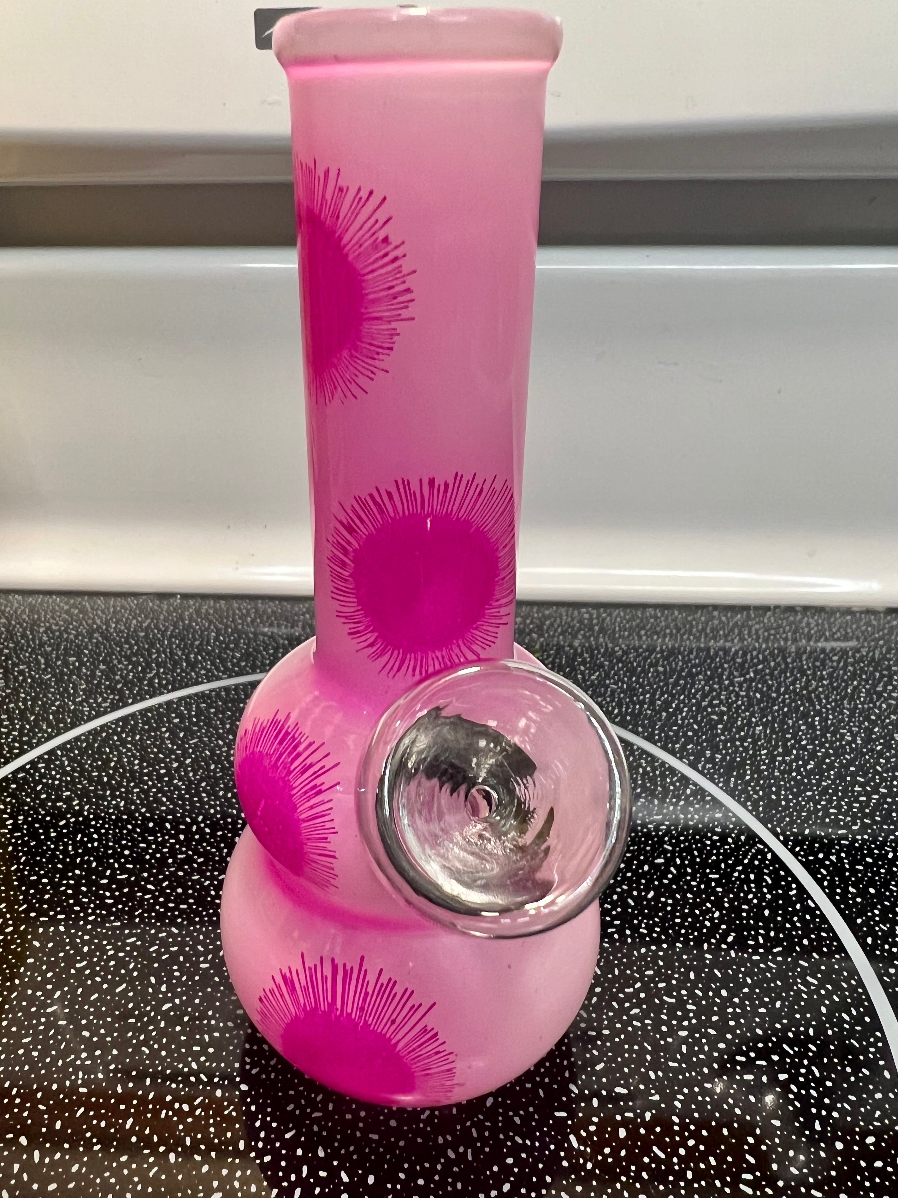 Ripkitty 5-inch soft glass water pipe, pink with starburst print, double-bubble base detail, bowl piece visible, front angle view