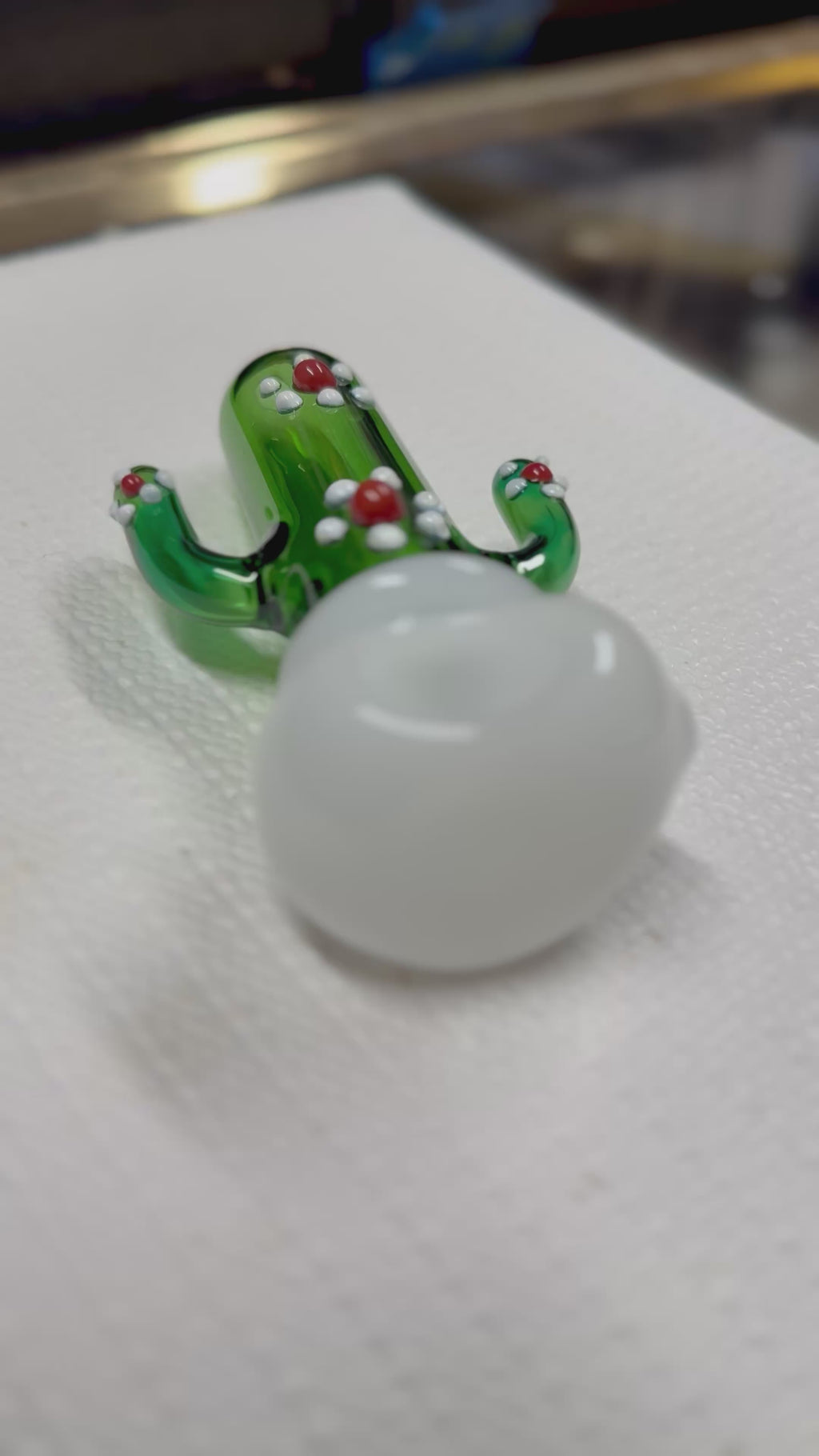 Ripkitty 4.5" cactus borosilicate glass spoon pipe — 360° display video showing green sculpted saguaro cactus body, raised white dot nodules, red glass bead