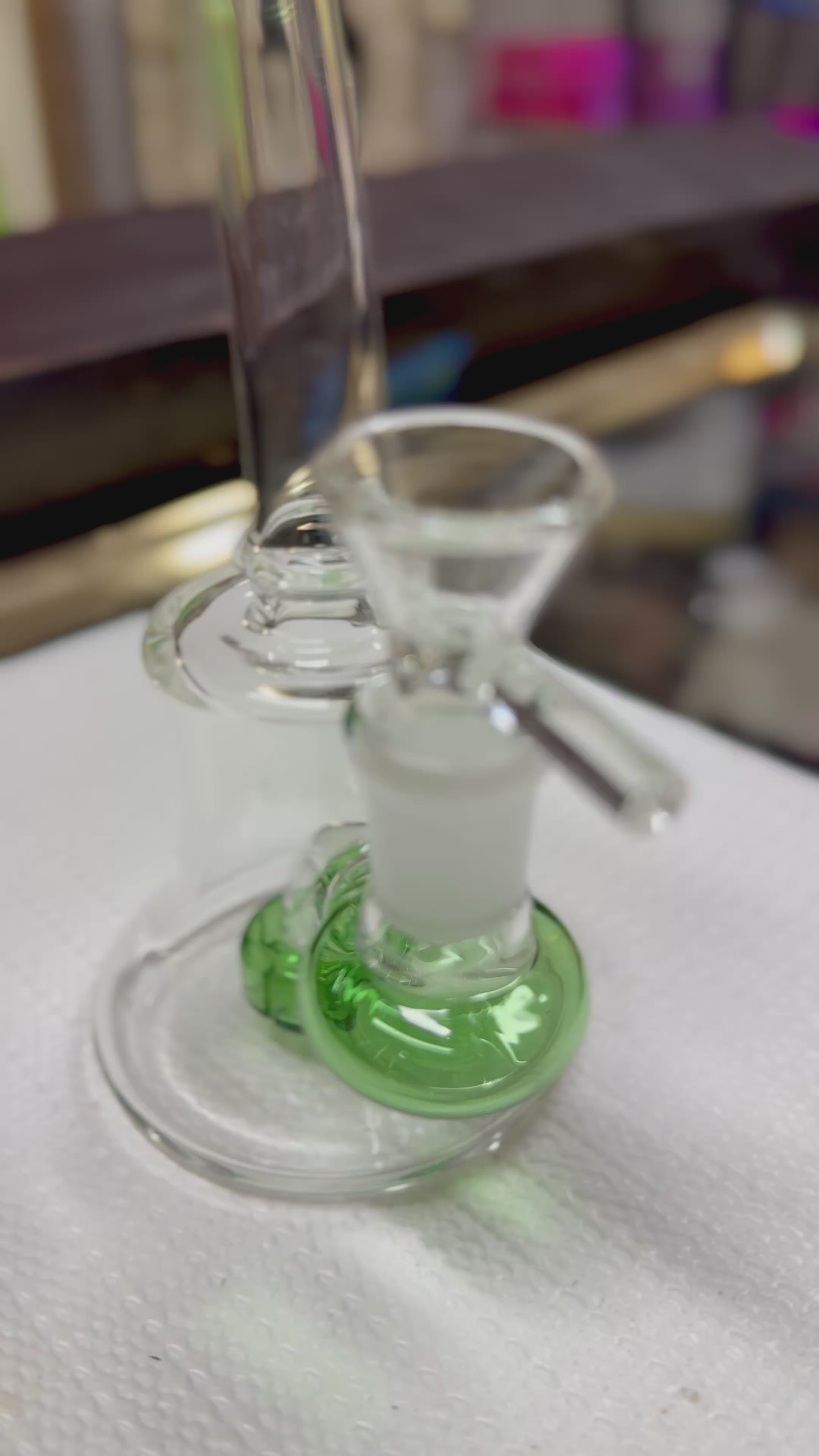 Ripkitty 7" conical bong — close-up display video highlighting iridescent color shower twist pattern in neck glass and percolator base detail